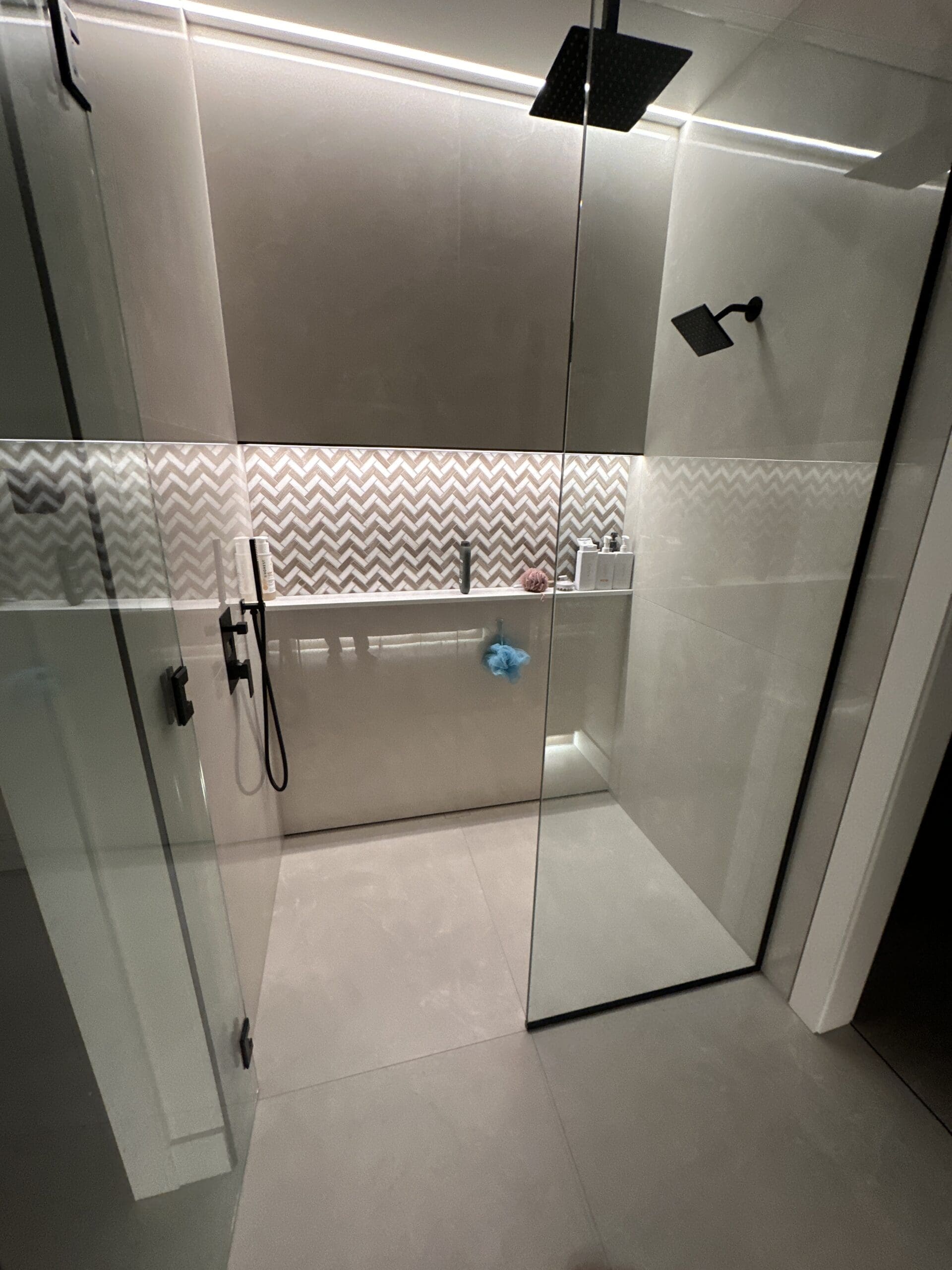 Modern walk-in shower with chevron accent