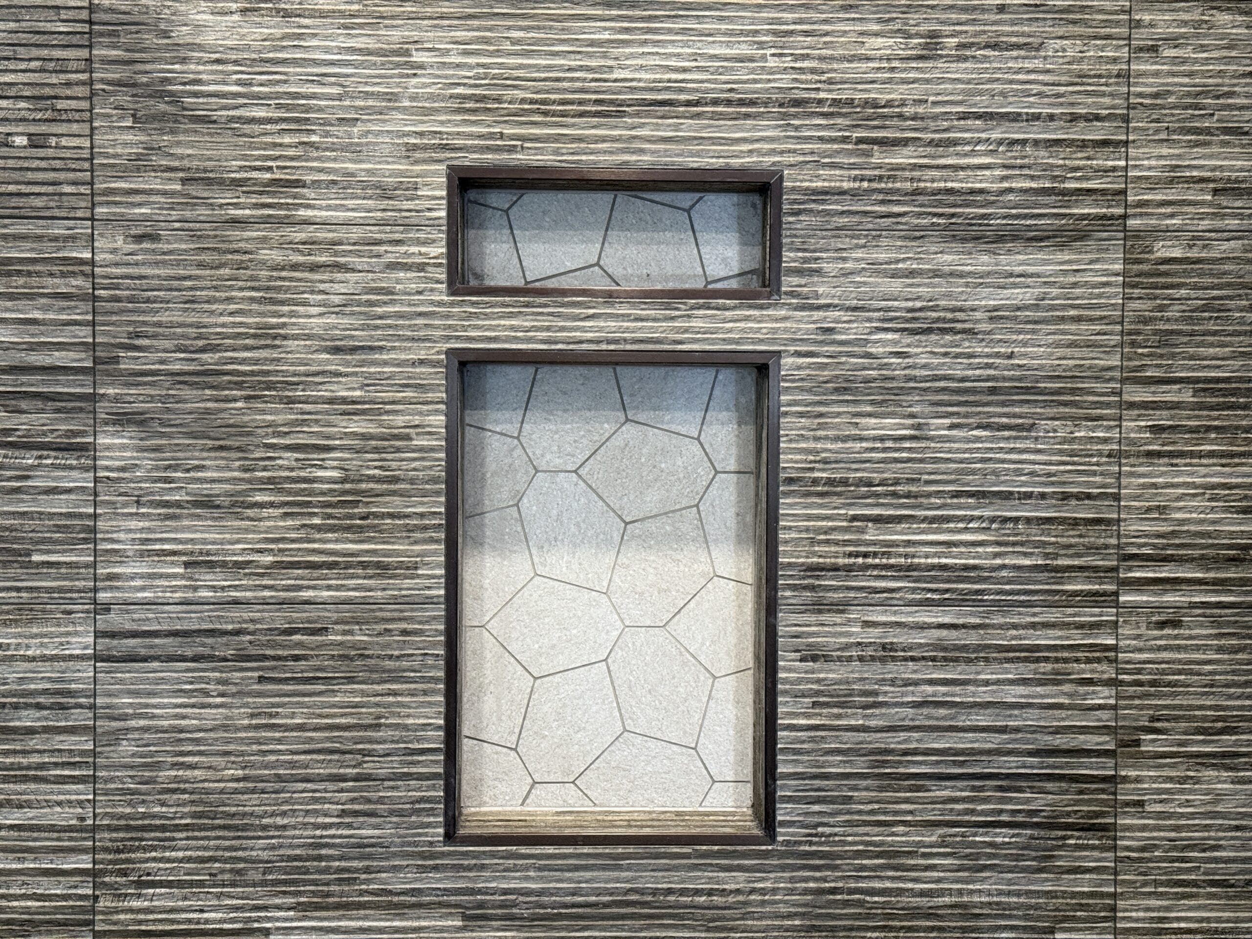 Woodgrain-look tile accent wall with recessed niches