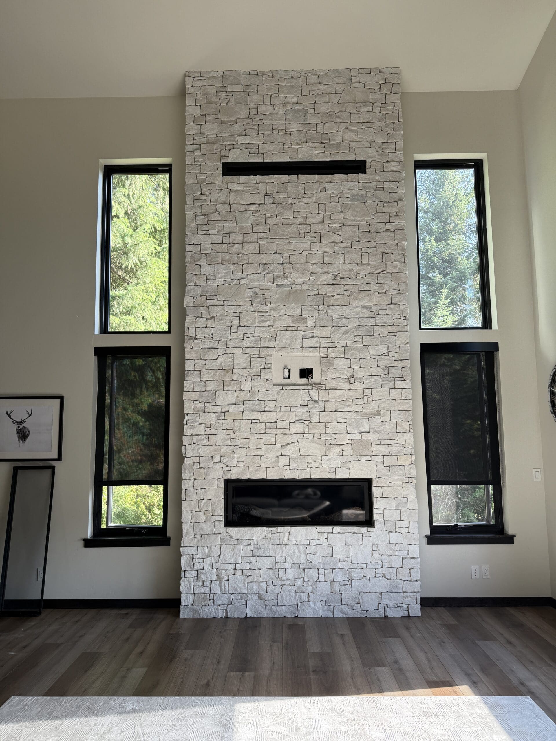 Floor-to-ceiling stacked stone fireplace feature wall