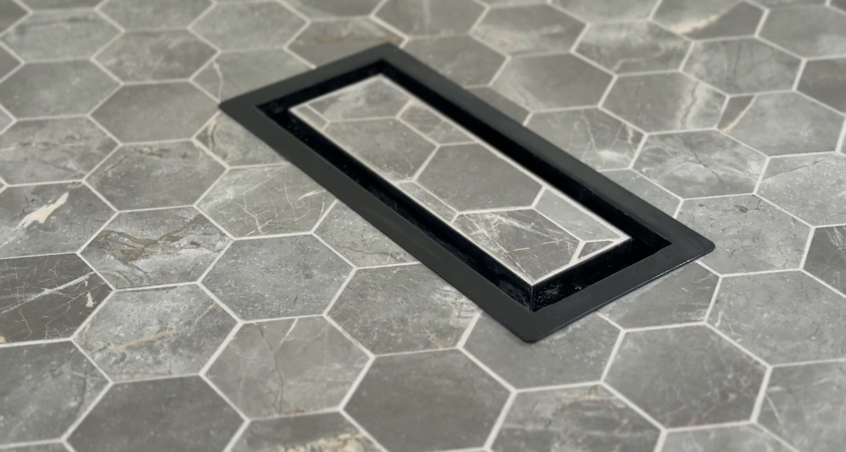 Hex tile shower floor with black linear drain