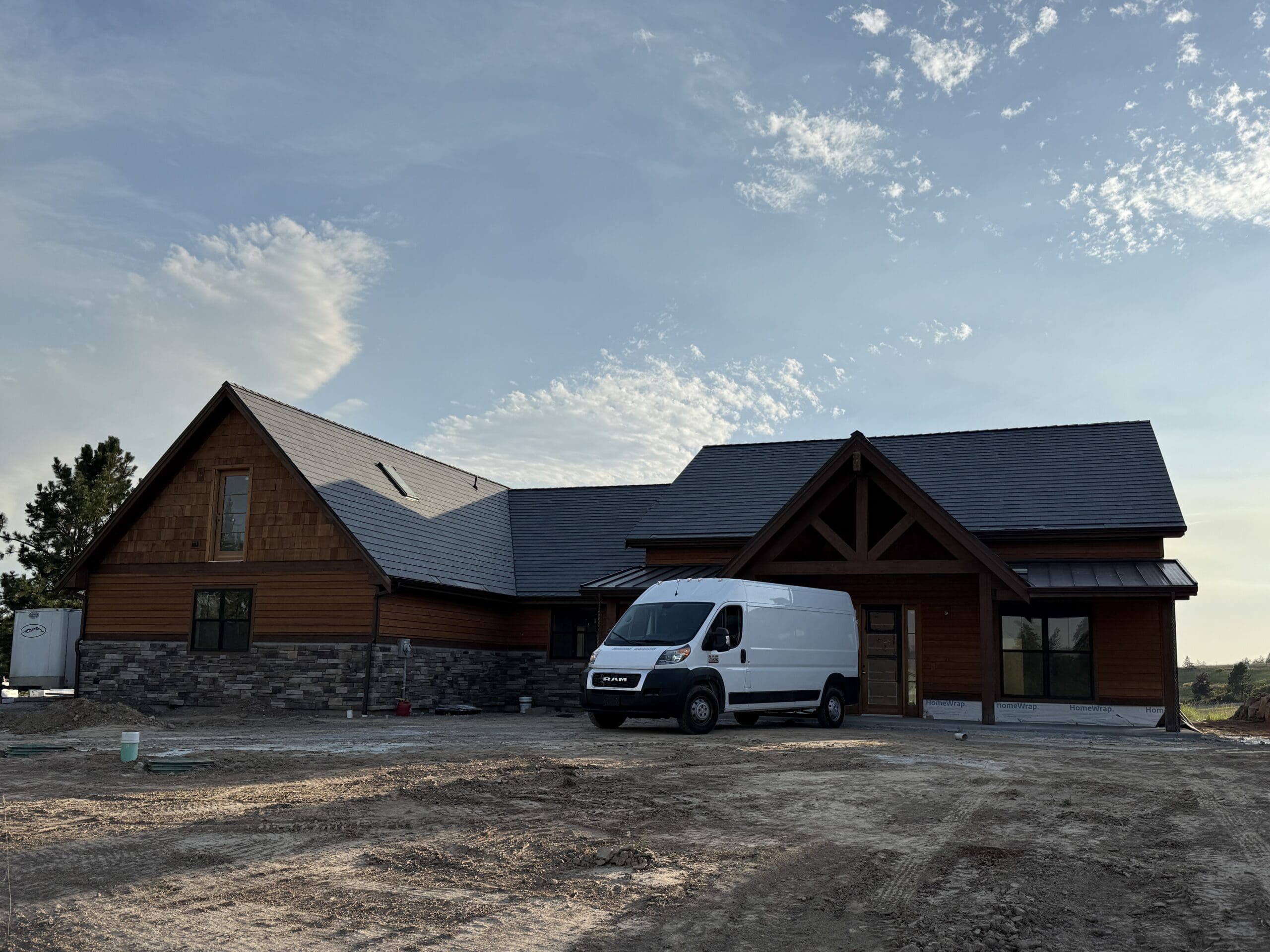 Tile contractor van parked in front of a newly built home at a jobsite in Spokane, WA.