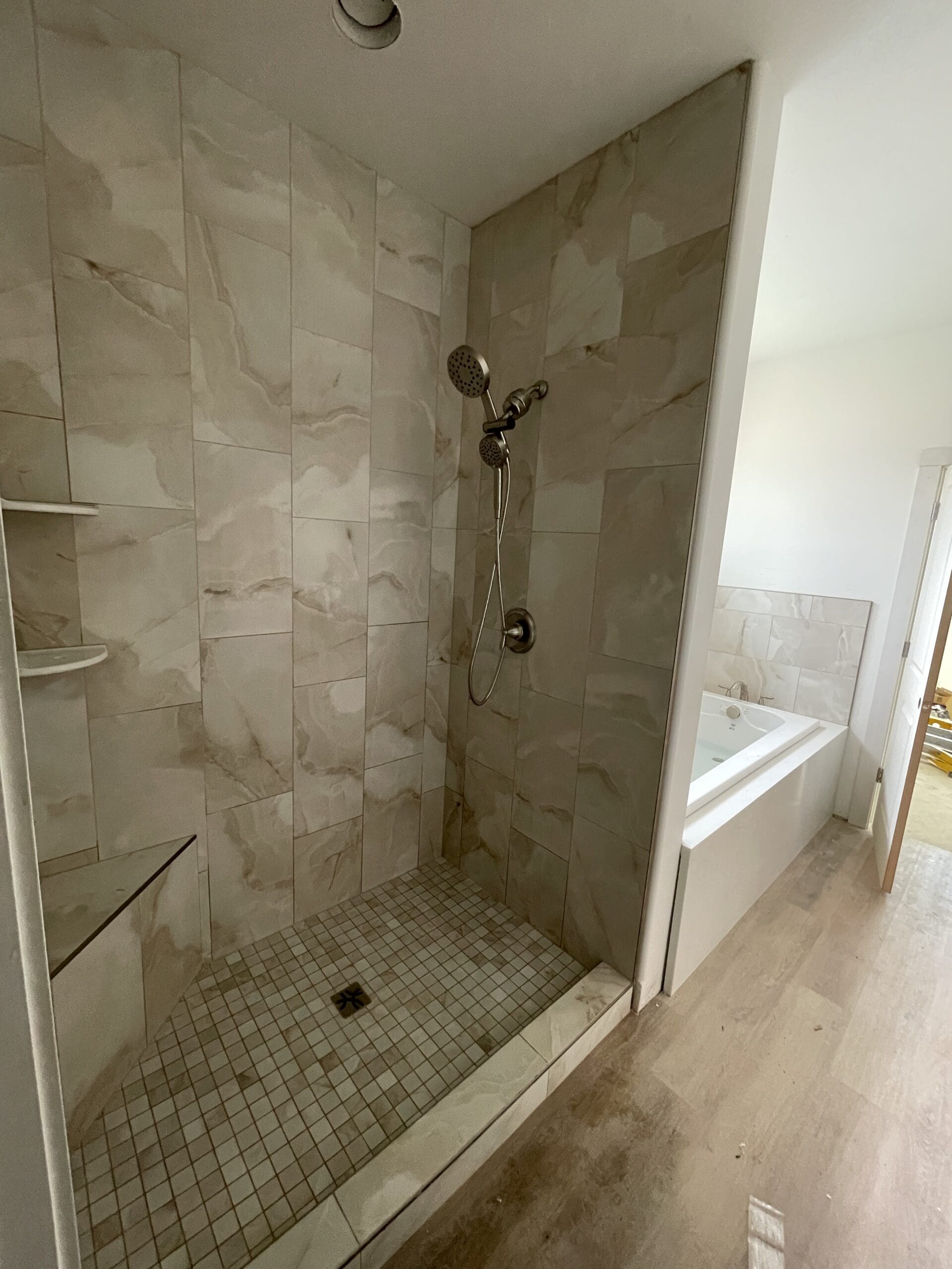 Beige stone-look shower with mosaic pan